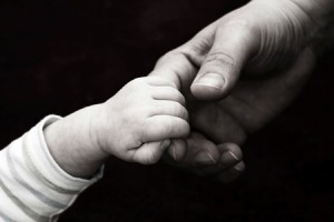 Marijuana Refugees: Changing States to Save Their Kids, Source: http://www.sweetfertility.com/wp-content/uploads/2012/10/holding_baby_hand_105089895.jpg